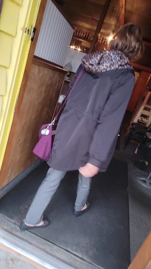 Wooden chairs and warm lighting inside.